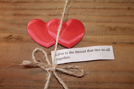 Two silky love hearts next to a loving quote and thread