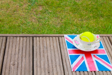 British Tennis - a cup and saucer and a tennis ball on a Union Jack flagの素材