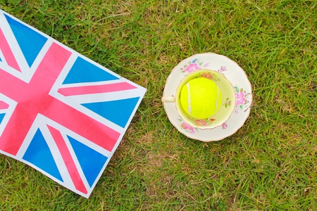 British Tennis - a cup and saucer and a tennis ball on a Union Jack flagの素材
