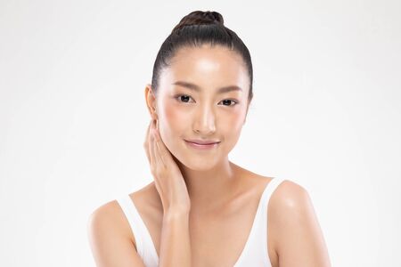 Beautiful Asian woman touching soft cheek smile with clean and fresh skin Happiness and cheerful with positive emotional,isolated on white background,Beauty and Cosmetics Conceptの写真素材