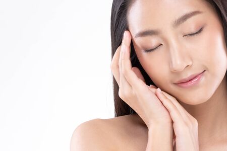 Beautiful Young Asian Woman Holding Hands Close her eyes smile feeling so happy and cheerful with healthy Clean and Fresh skin,isolated on white background,Beauty Cosmetology Conceptの写真素材