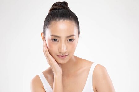 Beautiful Asian young woman touching soft cheek smile with clean and fresh skin Happiness and cheerful with positive emotional,isolated on white background,Beauty and Cosmetics Conceptの写真素材