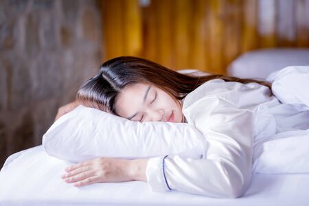 Beautiful Attractive Asian woman sleep and sweet dream on bed in bedroom in the morning feeling so...