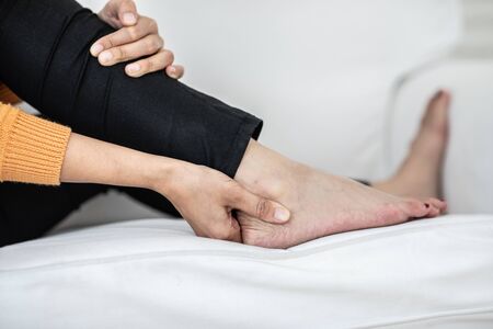 young Asian woman have a ankle pain,Healthcare Concept