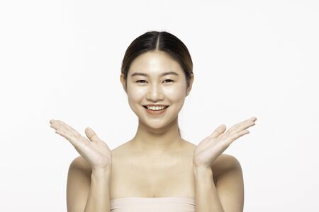 Beautiful Attractive Charming Asian young woman smile with white teeth open hand palm for display cosmetics product cheerful with healthy skin,isolated on white background,Beauty Cosmetology Conceptの写真素材