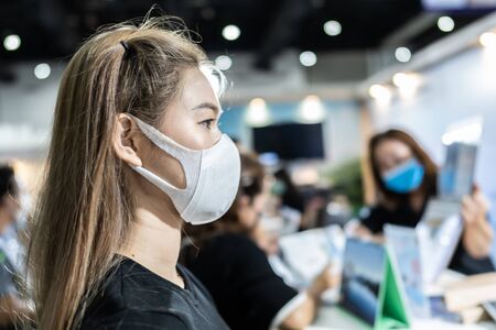 woman wearing protection mask standing in exhibition and be congested with virus...