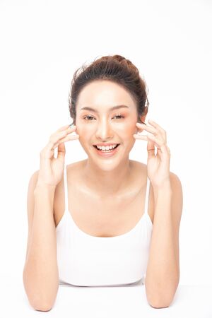Beautiful Asian woman touching soft cheek smile with clean and fresh skin Happiness and cheerful with positive emotional,isolated on white background,Beauty and Cosmetics Conceptの写真素材