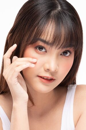 Young Beautiful Asian woman smile touching soft cheek with clean and fresh skin Happiness and cheerful with positive emotional,isolated on white background,Beauty Cosmetics and spa Treatment Conceptの写真素材