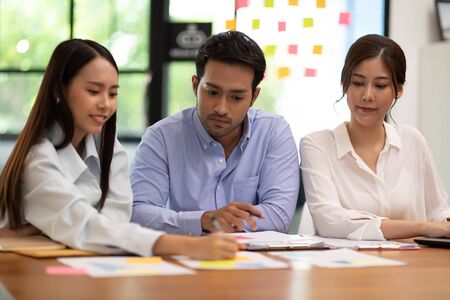 Group of young Startup coworkers working together to get ideas and marketing at office,Business Startup Diversity Brainstorming Conceptの写真素材