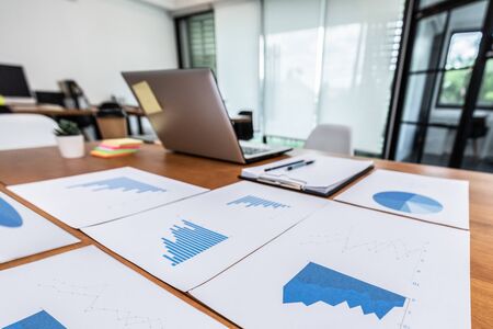 Close up fo Business document on working table with laptop and business chart