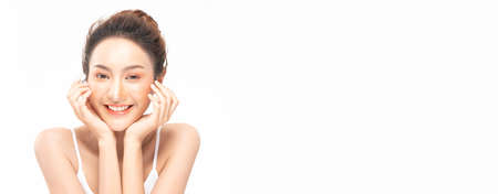 banner of Beautiful Asian woman touching soft cheek smile with clean and fresh skin Happiness and cheerful with positive emotional on white background,Beauty Cosmetics and spa facial treatment Conceptの写真素材