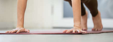 Athlete Asian woman looking laptop practice yoga online course at home to meditation comfortable and...