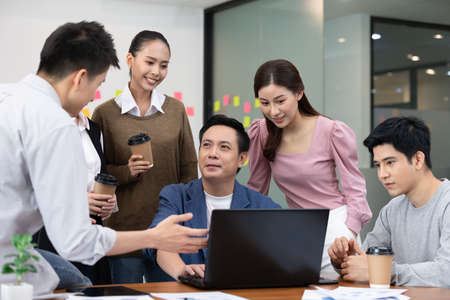 Group of Happy young business Startup coworkers working Brainstorming together to get ideas and...