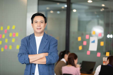 Asian senior business men leader standing smile cross arm and confidence at Co-Working space,Small Business Startup Conceptの写真素材