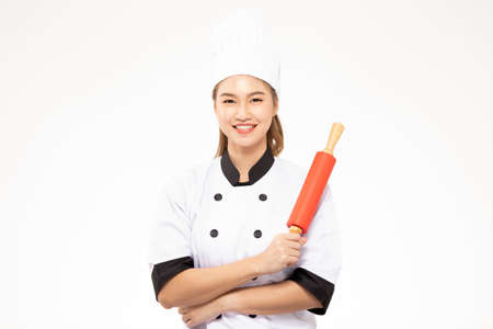 Beautiful Asian chef woman smile and holding rolling pin isolated on white background,Happiness and Cheerful Professional chef Conceptの写真素材