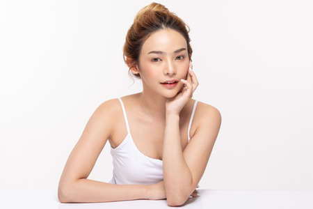 Beautiful Asian young woman touching soft cheek smile with clean fresh skin Happiness and cheerful with positive emotional,isolated on white background,Beauty Cosmetics and Facial treatment Conceptの写真素材