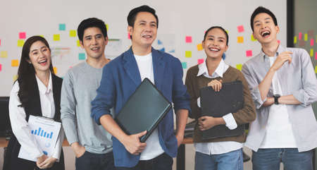 Group of Happy young business Startup coworkers working Brainstorming together to get ideas and marketing plan at office,Business Startup Diversity Conceptの写真素材