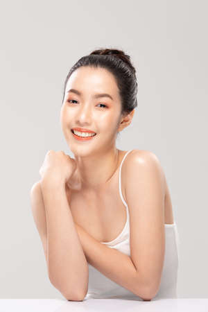 Beautiful Asian young woman touching soft cheek smile with clean and fresh skin Happiness and cheerful with positive emotional,isolated on white background,Beauty and Cosmetics Conceptの写真素材