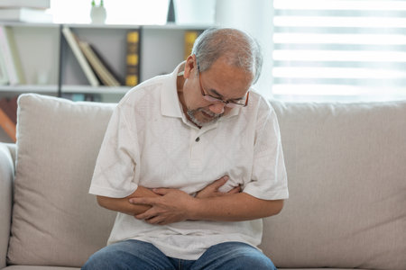 Asian Elderly senior man stomach ache so pain and illnessの写真素材