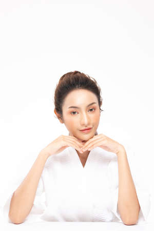 Beautiful Asian woman touching soft cheek smile with clean and fresh skin Happiness and cheerful with positive emotional,isolated on white background,Beauty Cosmetics and spa Treatment Conceptの写真素材