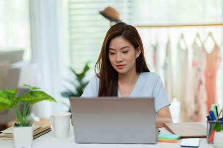 Entrepreneur of beautiful business asian young woman working online with laptop at home,Freelance woman working online sale marketing at home,Small Business Startup conceptの写真素材