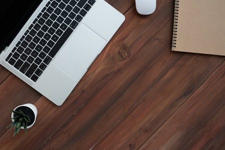 Top view of Computer laptop notebook and mouse on wooden table,Flat lay business concept with copy...