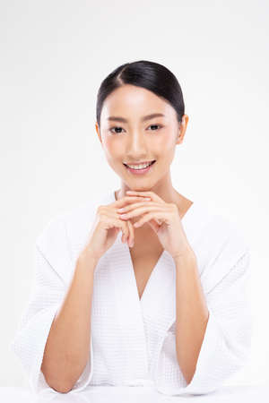 Beautiful Asian woman looking at camera holding hands smile with clean and fresh skin Happiness and cheerful with positive emotional,isolated on white background,Beauty and Cosmetics Conceptの写真素材