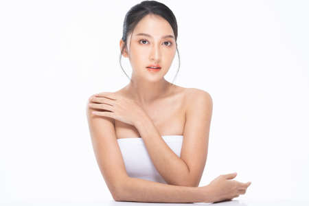 confidence young woman is showing her soft and flawless skin. Model posting make her beautiful and attractive. Stunning female got long black hair. Strapless dress can make us see all her clear dermisの写真素材