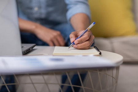 Close up hand of business man holding pen and writing to do list or calculated in book. Writing work...