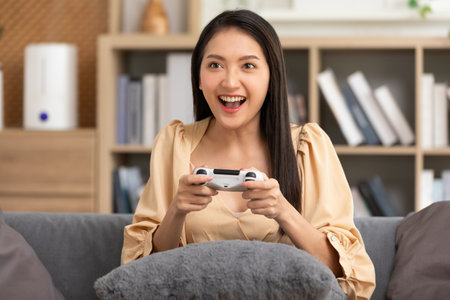 Young woman using joystick playing video game. Female win the game in hard match, looking at the...