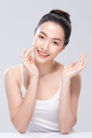 Beautiful Asian woman looking at camera smile with clean and fresh skin Happiness and cheerful with positive emotional,isolated on white background. Beauty and Cosmetics Concept. Proud her self.の写真素材