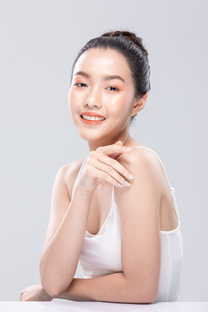 Beautiful Asian woman looking at camera smile with clean and fresh skin Happiness and cheerful with positive emotional,isolated on white background. Beauty and Cosmetics Concept. Proud her self.の写真素材