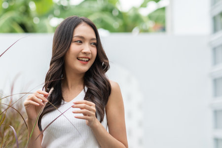 Beautiful asian young woman smile and cheerful. Confident cute female looking at camera relax and happiness with wellness life. good moment and positive emotional. Happy woman enjoy her life conceptの写真素材