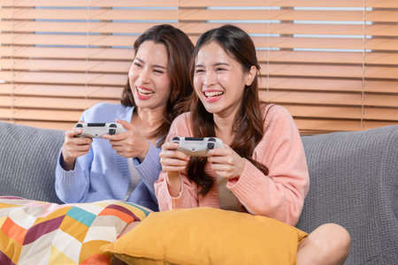 LGBT couple of lovers playing console games together, radiating happiness love, fun, and togetherness in the LGBTQ community. LGBT Pride Monthの写真素材