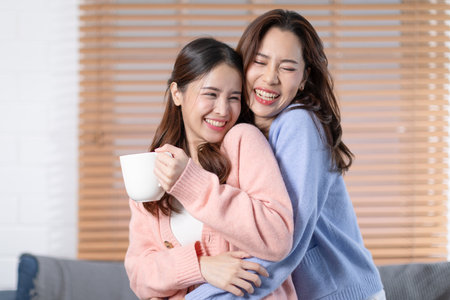 Beautiful two Asian female LGBT lesbian embracing with love and romance , Positive mood and good moment with quality time at warmth place.LGBTQ+ Lifestyle Pride Monthの写真素材