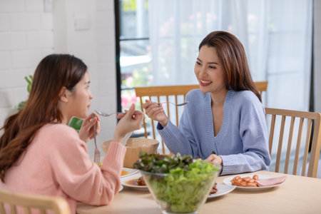 Couple LGBTQ lover cooking in kitchen together smile and laughing. Happiness and tender moment quality time at home. LGBTQ+ Conceptの写真素材