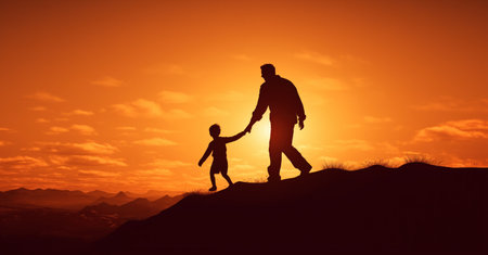 A father and son holding hands on a hill during sunsetの素材