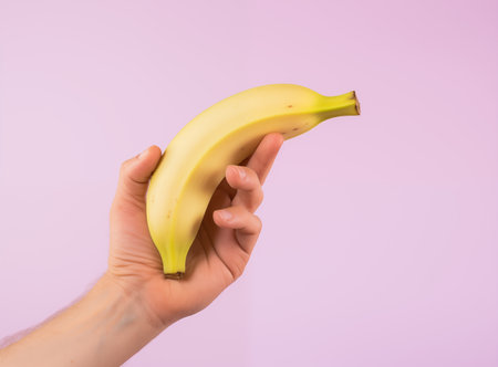 A hand holding a banana. Man's sexual healthの素材
