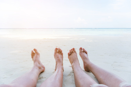 Couple relaxing in summer holiday on beachの写真素材