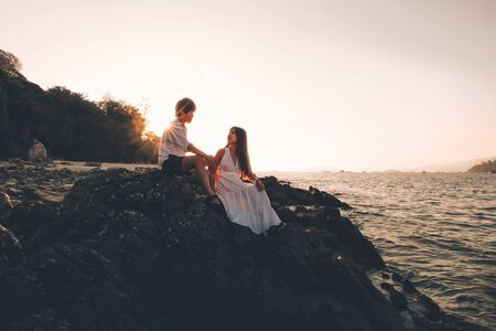 Couple relaxing beautiful sunset on Koh Lipe Beach Thailand ,Summer vacation