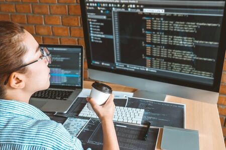 Developing Concentrated programmer reading computer codes Development Website design and coding technologies.の写真素材