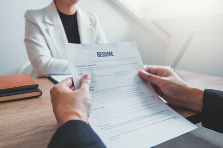 Senior manager HR reading a resume during a job interview employee young man meeting Applicant and recruitmentの写真素材