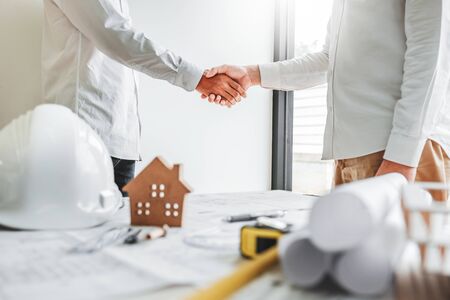 Team Engineer colleagues shaking hands and meeting for architectural project on workplace