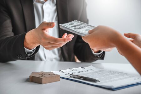Woman customer sign agreement buying home ,salesman receive money after good deal after successful...
