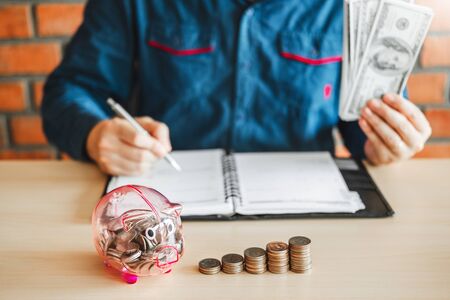 Man calculator Accounting Calculating with Piggy bank money stack step growing saving moneyの写真素材
