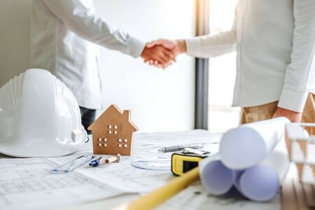 Team Engineer colleagues shaking hands and meeting for architectural project on workplace