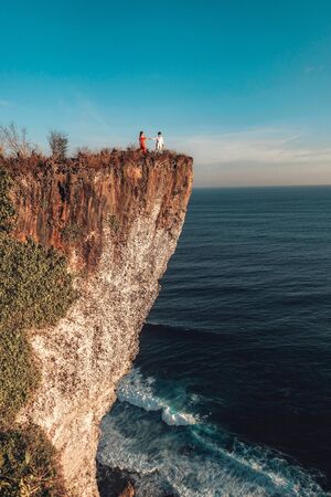 Couple Adventure and looking view on the karang boma cliff at Uluwatu Bali in Indonesiaの写真素材