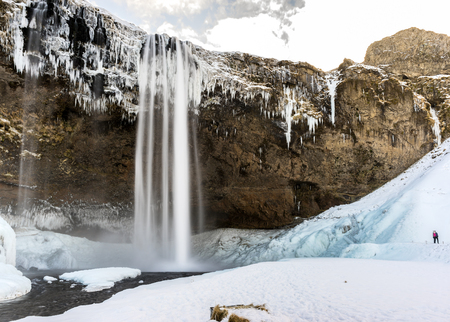 The Seljalandsfoss waterfall in the south of Iceland shown during the winter.の写真素材