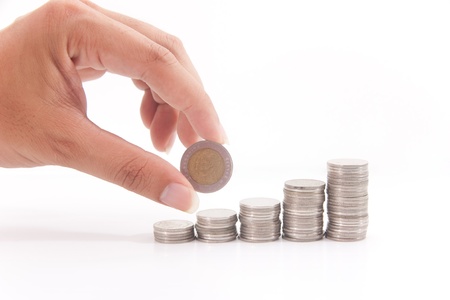 Stack money and a hand in action on white isolateの写真素材