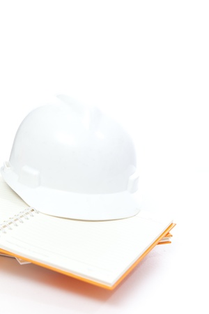 Helmet on book stack in white isolatedの写真素材